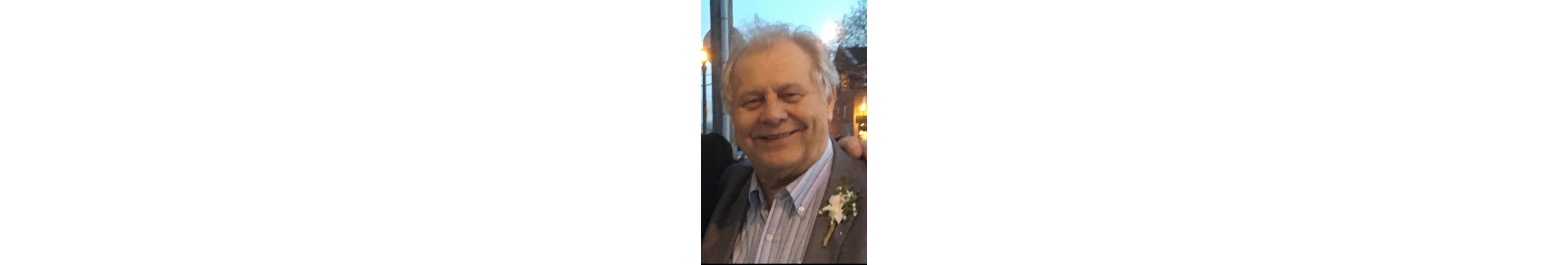 Walter Rebot smiling in a suit jacket with a boutonniere